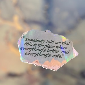 May include: A holographic sticker with a quote that reads, "Somebody told me that this is the place where everything's better and everything's safe."