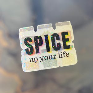 May include: A holographic sticker featuring four spice bottles with the text "SPICE up your life".