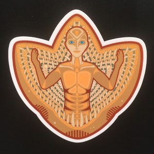 May include: A sticker featuring a stylized figure with blue eyes and outstretched arms. The figure is in shades of orange and brown, surrounded by a woven pattern. The sticker has a white border and a black background.