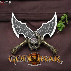 May include: A pair of silver and black blades with intricate designs, crossed in the center. The blades are labeled "God of War" and "God of War III".