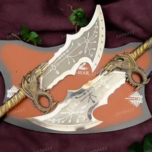 May include: A pair of silver and gold-colored swords with intricate designs and chains. The swords are displayed on a brown and gray background with the word "WAR" printed on it.