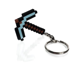 May include: A blue and brown plastic Minecraft pickaxe keychain with a silver metal ring and chain.