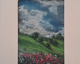 May include: A pastel drawing of a landscape with rolling green hills, a blue sky with white clouds, and a field of pink flowers in the foreground.