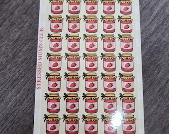 May include: A rectangular card with a grid of illustrated jam jars, each with a strawberry inside. The card reads "JAN JAR SAVER" and "EACH JAM JAR - SAVES -" with the text "STRESSED MUM'S CLUB" on the side. Strawberries decorate the top.