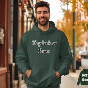 May include: Forest green hoodie with the text "Topdeck or Bust" in a white, stylized font. The hoodie has a front pocket and a hood. The image also includes a smaller image of the hoodie with the text "Forest Green".