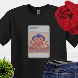 May include: Black t-shirt with a graphic of a cartoon octopus wearing a blue hat and holding a flag. The graphic is inside a social media post frame with the text "Marked safe from Annihilator 6".