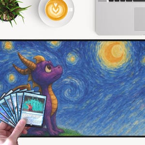 May include: A large rectangular mousepad featuring a purple dragon character set against a starry night sky background. The dragon is looking up, and a hand holds a fan of trading cards in front of the dragon. The background is a stylized painting.