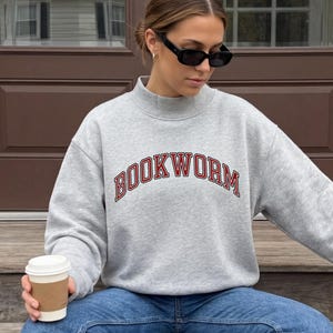 Bookworm Mockneck Sweatshirt: Women's Oversized Collegiate Graphic sweatshirt for book lovers