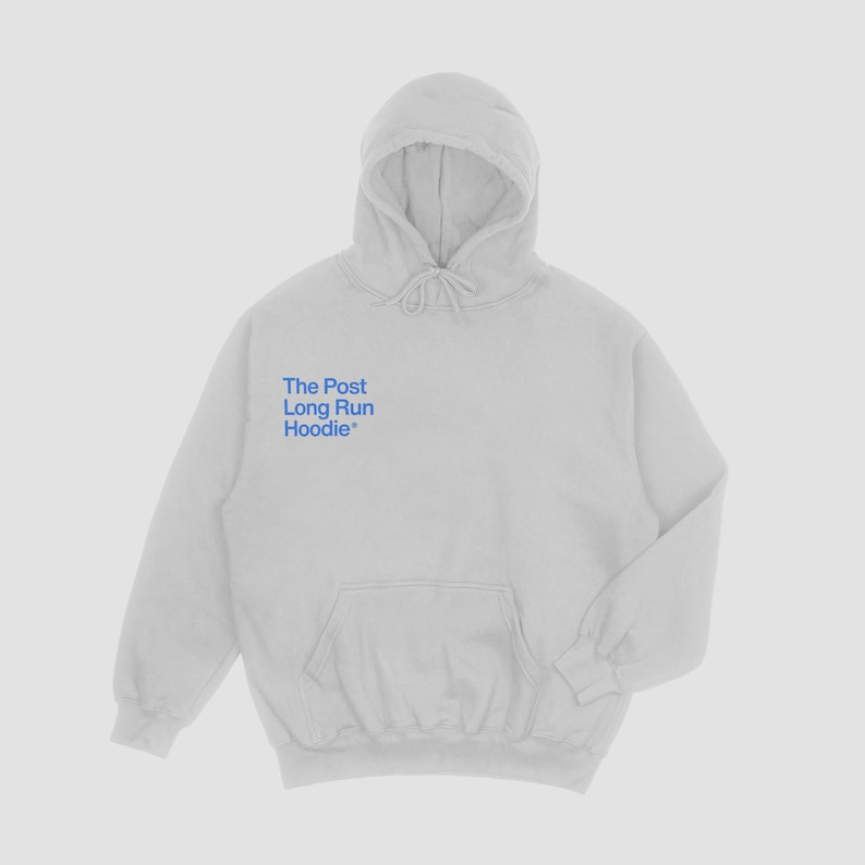 May include: A light gray hoodie with a drawstring hood and a kangaroo pocket. The text "The Post Long Run Hoodie" is printed in blue on the chest. The hoodie is made of a soft material.