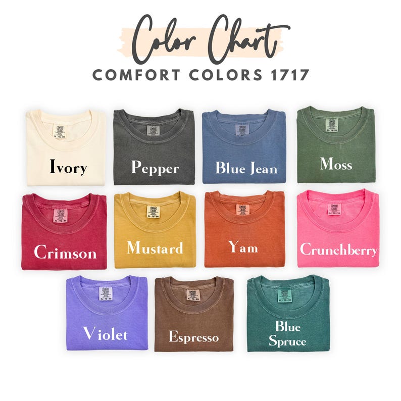 May include: A color chart displays folded t-shirts in various colors, including Ivory, Pepper, Blue Jean, Moss, Crimson, Mustard, Yam, Crunchberry, Violet, Espresso, and Blue Spruce. The text "Color Chart" and "Comfort Colors 1717" are at the top.