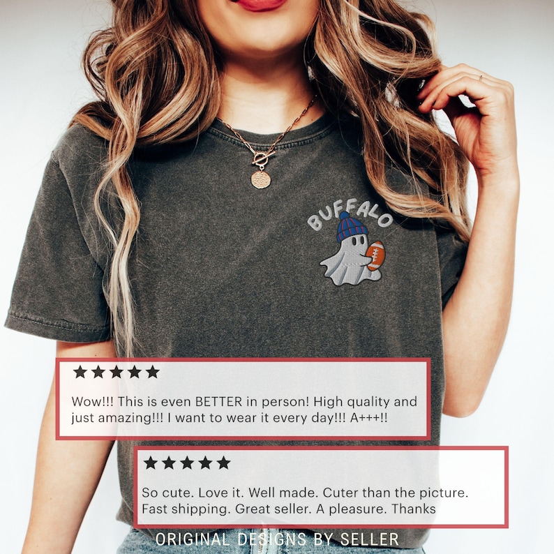 May include: Dark gray t-shirt with an embroidered design of a ghost wearing a blue beanie and holding a football. The word "BUFFALO" is arched above the ghost. Customer reviews are displayed below the design.