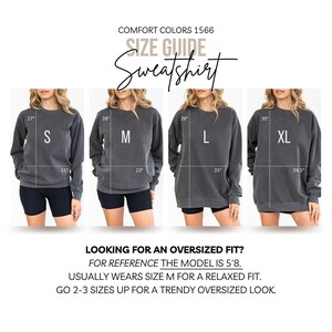 May include: Size guide for a Comfort Colors 1566 sweatshirt. The image shows four models wearing the sweatshirt in sizes S, M, L, and XL. The text on the image reads "Looking for an oversized fit?" and provides sizing guidance.