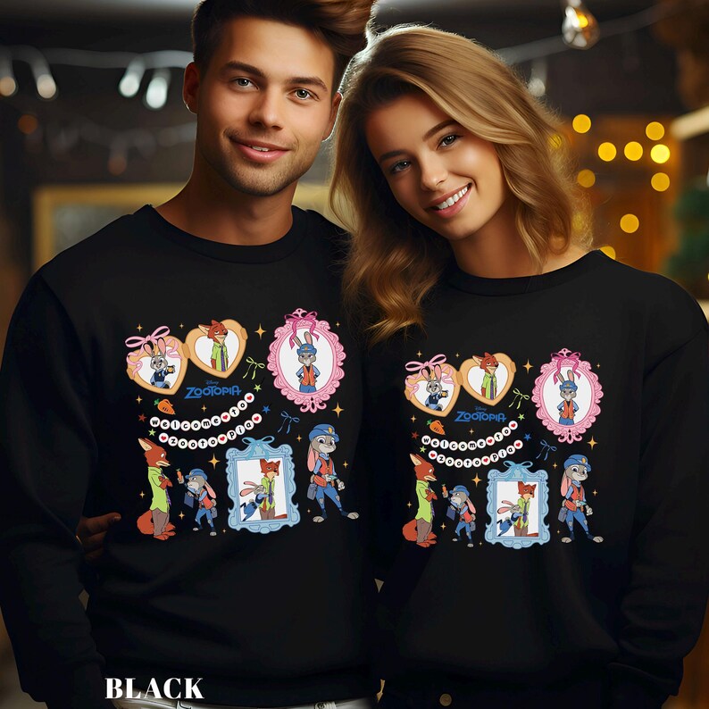 May include: Black sweatshirts featuring a colorful cartoon design from the movie Zootopia. The design includes characters in decorative frames and hearts, with the word "Zootopia" and the word "BLACK" at the bottom.