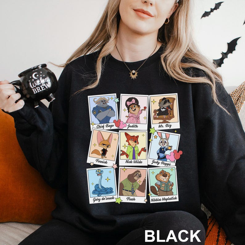 Puede incluir: Sudadera negra con retratos de personajes de dibujos animados de una pel&iacute;cula. Los retratos incluyen a Chief Bogo, Judith, Mr. Big, Finnick, Nick Wilde, Judy Hopps, Gary de'snack, Flash y Nibbles Maplestick. La palabra "BLACK" est&aacute; impresa en la parte inferior.