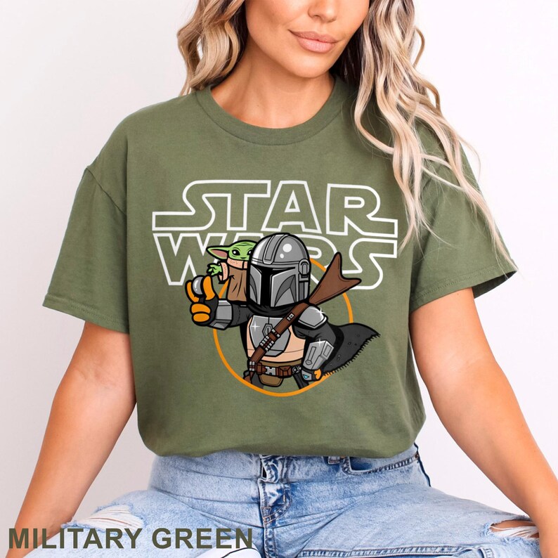 May include: A green t-shirt with a white "Star Wars" graphic featuring a cartoon Mandalorian and Grogu.