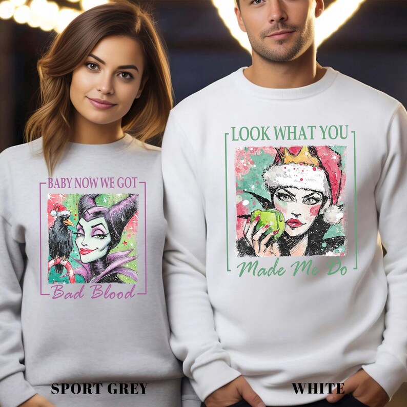 Puede incluir: Sudaderas deportivas grises y blancas con ilustraciones gr&aacute;ficas. La sudadera gris deportiva presenta una caricatura de una mujer con un cuervo y el texto "Baby Now We Got - Bad Blood". La sudadera blanca tiene una mujer con una corona y el texto "Look What You - Made Me Do".