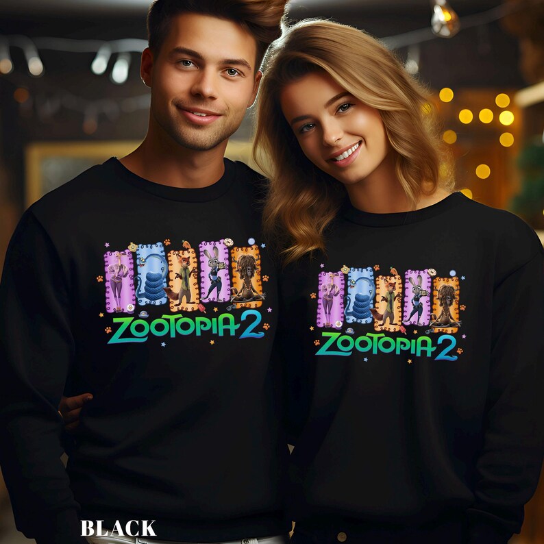 May include: Black sweatshirts featuring a colorful "Zootopia 2" graphic. The design includes various cartoon characters in rectangular frames. The text "BLACK" is at the bottom of the image.