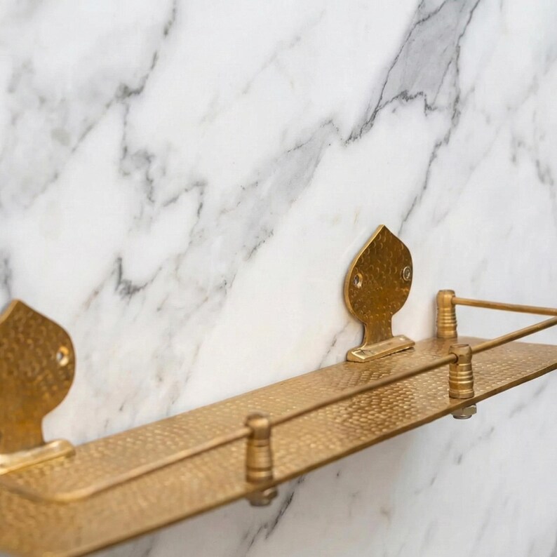 Side angle of a brass wall ledge, showing the floating design and the depth of the shelf. The solid brass construction looks sturdy and elegant