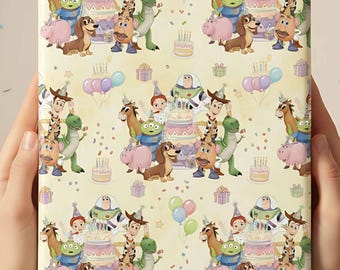 May include: A square gift box wrapped in patterned paper featuring cartoon characters, birthday cakes, and balloons. The design includes characters like Woody, Buzz Lightyear, and others from the Toy Story franchise, set against a light yellow background.