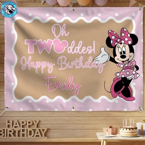 May include: A rectangular pink and tan birthday banner featuring a white scalloped border and white polka dots. The text reads Oh TWOoddes! Happy Birthday Emily. A graphic of Minnie Mouse wearing a pink polka dot dress and bow is on the right.