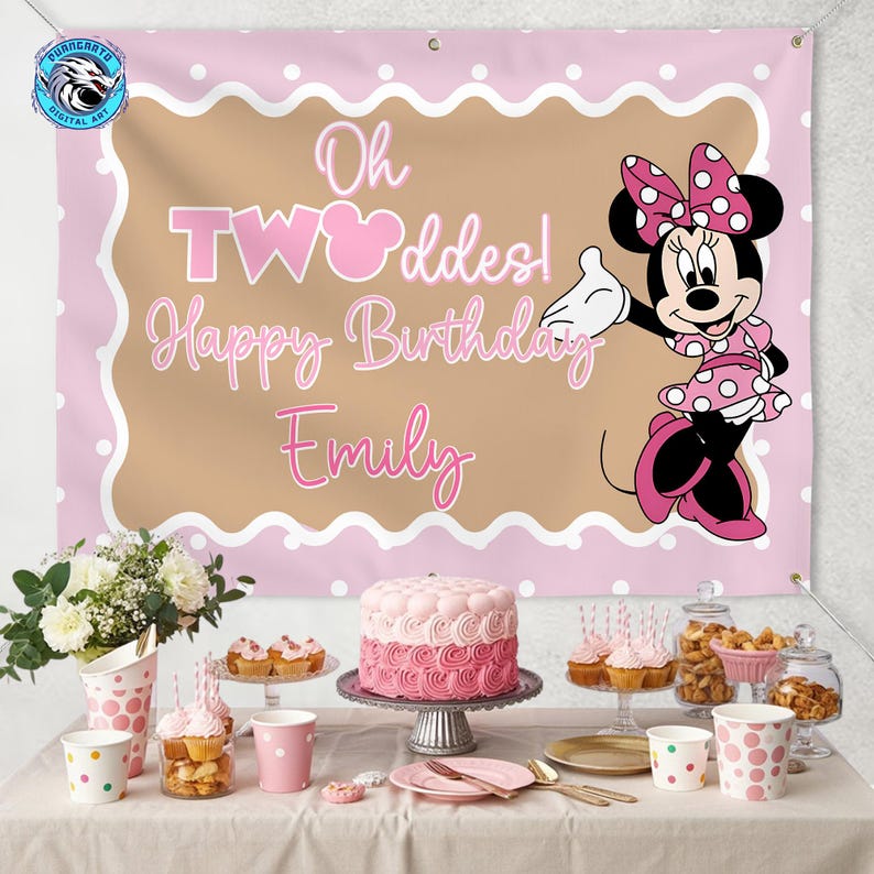 May include: A rectangular pink and tan birthday banner featuring a cartoon mouse in a polka dot dress and bow. The text reads Oh TWOddes! Happy Birthday Emily in white and pink script. The banner has white polka dots and scalloped edges.