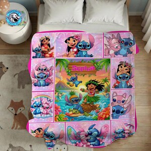 May include: A pink and white blanket featuring various images of the characters Lilo and Stitch. The blanket has a collage design with images of the characters in different poses and settings. The name "Sophia" is displayed on a wooden sign.