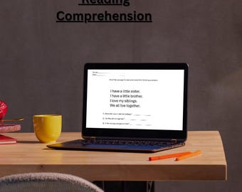 May include: A laptop computer with a white screen displaying a reading comprehension worksheet with the text "I have a little sister. I have a little brother. I love my siblings. We all live together."  The laptop is on a wooden table with a yellow mug and two orange pencils.