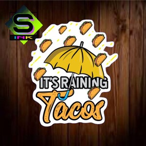 May include: A yellow umbrella with the text "It's Raining Tacos" in white letters.  The umbrella is surrounded by cartoon tacos falling from the sky.