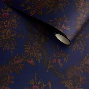 May include: A roll of navy blue wallpaper with a repeating floral pattern in shades of brown and pink. The design features stylized flowers and foliage, creating a classic, elegant look. The wallpaper is partially unrolled, revealing the pattern.