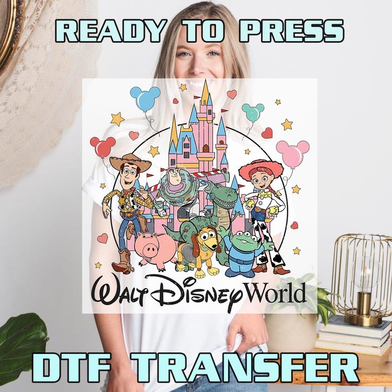 May include: White DTF transfer featuring a colorful illustration of Disney characters, including Woody, Buzz Lightyear, and Jessie, in front of a pink castle. The words "Walt Disney World" are below the characters, with "READY TO PRESS" and "DTF TRANSFER" above and below.