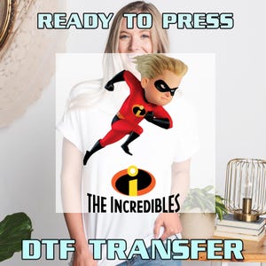 May include: White t-shirt featuring a graphic of Dash from The Incredibles in a running pose. The design includes the Incredibles logo and the text "THE INCREDIBLES". The words "READY TO PRESS" and "DTF TRANSFER" are also visible.