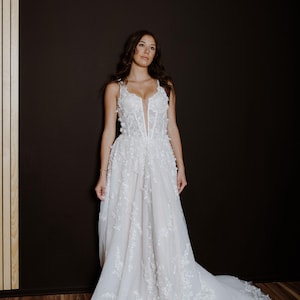 Romantic A-line gown with delicate floral details.