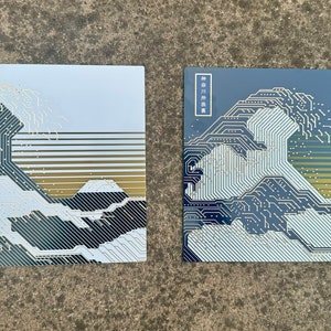 Both Variants of the Circuit Board Art with Sunlight reflecting off the gold traces