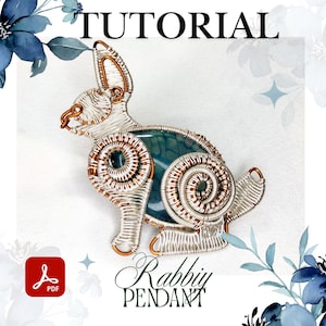 May include: A wire-wrapped rabbit pendant with a blue-green stone body. The pendant is made with silver and copper wire, and the word "TUTORIAL" is at the top. The words "Rabbit Pendant" are at the bottom.