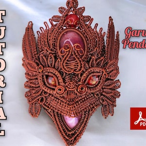 May include: A copper wire sculpture of a Garuda, a mythical bird-like creature from Hindu mythology, with red and pink gemstones. The sculpture is a pendant and is labelled "Garuda Pendant".