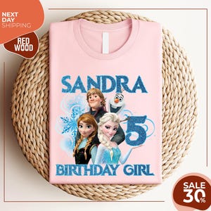 a pink shirt with a picture of two frozen princesses on it