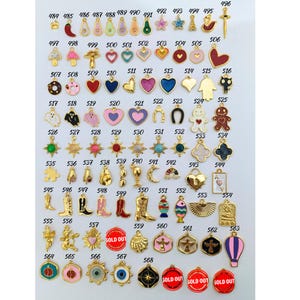 May include: Assortment of 68 gold-tone charms with colorful enamel designs. The charms feature various shapes, including hearts, stars, animals, and abstract designs. Some charms have text, such as "SOLD OUT".