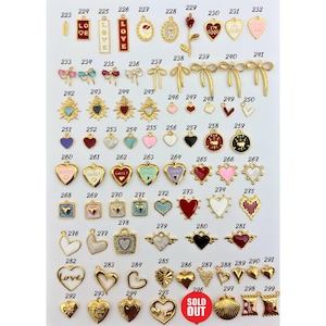 May include: Assortment of gold-tone metal charms with enamel accents. The charms feature hearts, bows, flowers, and words like "Love", "Sweet", and "I'm Good".