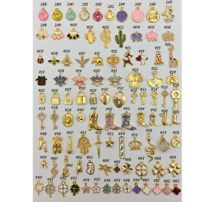 May include: Assortment of 50 gold-tone metal charms with various enamel colors and designs. Charms include a donut, cactus, bee, lock, cowboy boot, star, crown, snake, dragonfly, and clover.