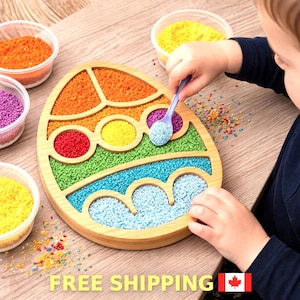 May include: A wooden sensory board in the shape of an Easter egg, filled with colourful beads. The board is divided into sections of orange, red, yellow, green, and blue beads. A child uses a purple spoon to move the beads. Small containers of beads are also visible.