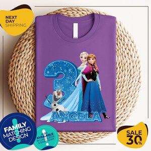 a purple shirt with a picture of two frozen princesses on it
