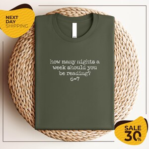 a green t-shirt with a humorous text printed on it, placed on a woven placemat.