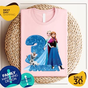 a pink shirt with a picture of two frozen princesses on it
