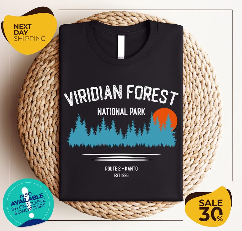 a black t-shirt with a graphic design depicting a forest scene, along with text indicating the location as Viridian Forest National Park.