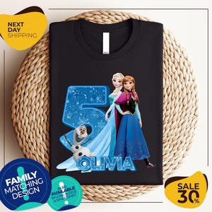 a black tshirt with a picture of two frozen princesses and the number