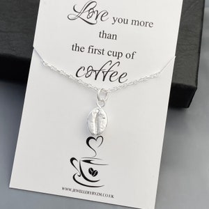 May include: Silver necklace with a coffee bean charm and a card that reads "Love you more than the first cup of coffee".