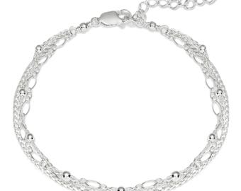 May include: Silver anklet with three delicate chains and small round beads.