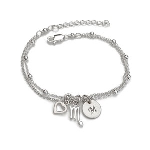 May include: Silver bracelet with a heart, a zodiac symbol, and a personalized charm with the letter "M".