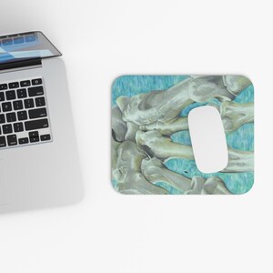 May include: A mouse pad with a detailed drawing of a hand skeleton on a blue and green background.