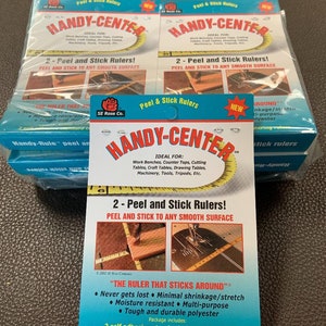 May include: Two packs of Handy-Center Peel and Stick Rulers. The rulers are ideal for workbenches, counter tops, cutting tables, craft tables, drawing tables, machinery, tools, tripods, and more. The rulers are self-adhesive and can be used on any smooth surface. The pack includes two rulers. The rulers are made of durable polyester and are moisture resistant. The rulers are designed to never get lost and have minimal shrinkage or stretch.